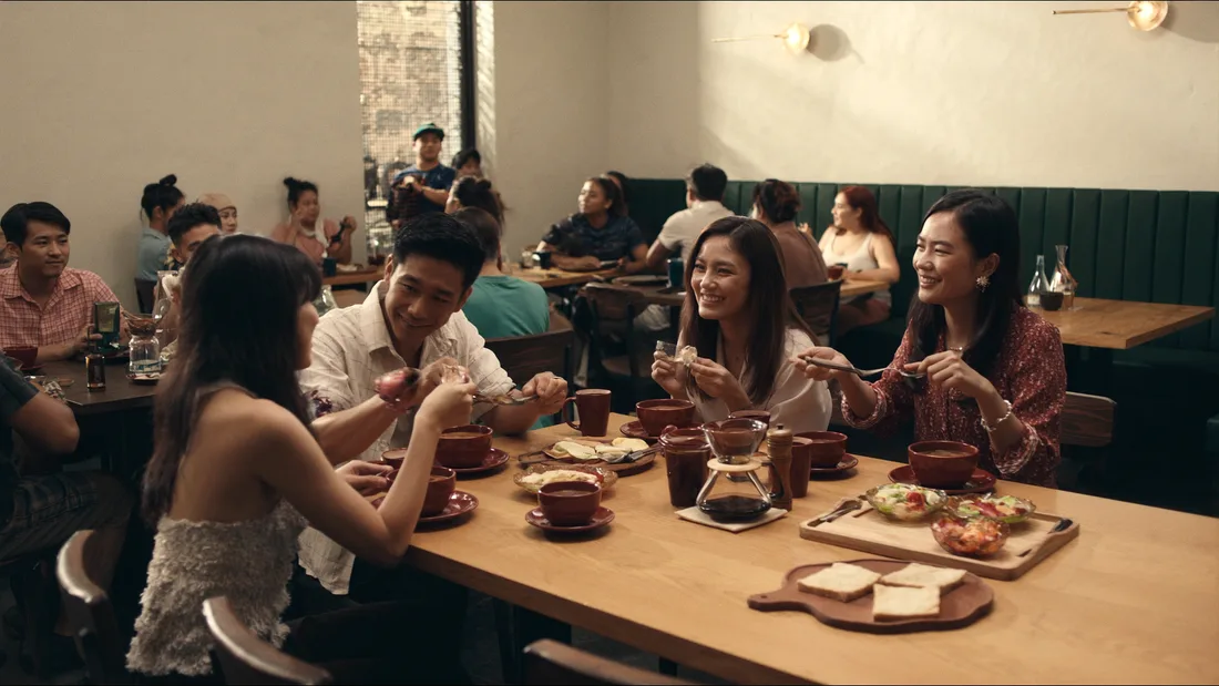 Concept scene of friends talking over a shared meal in a neighborhood restaurant.